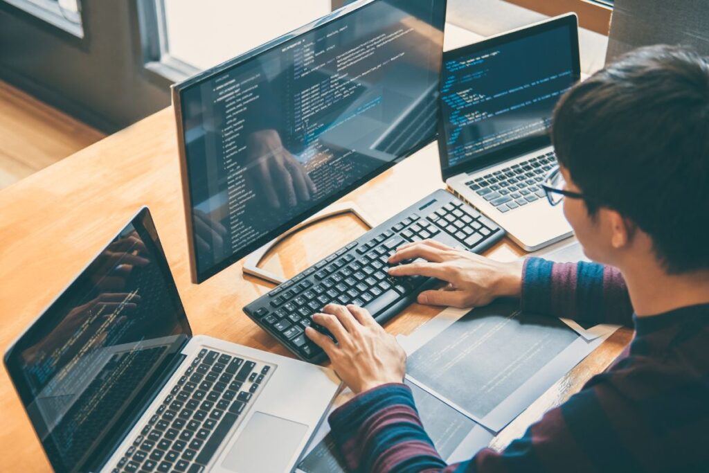 A person working on his computer setup - delivix web development